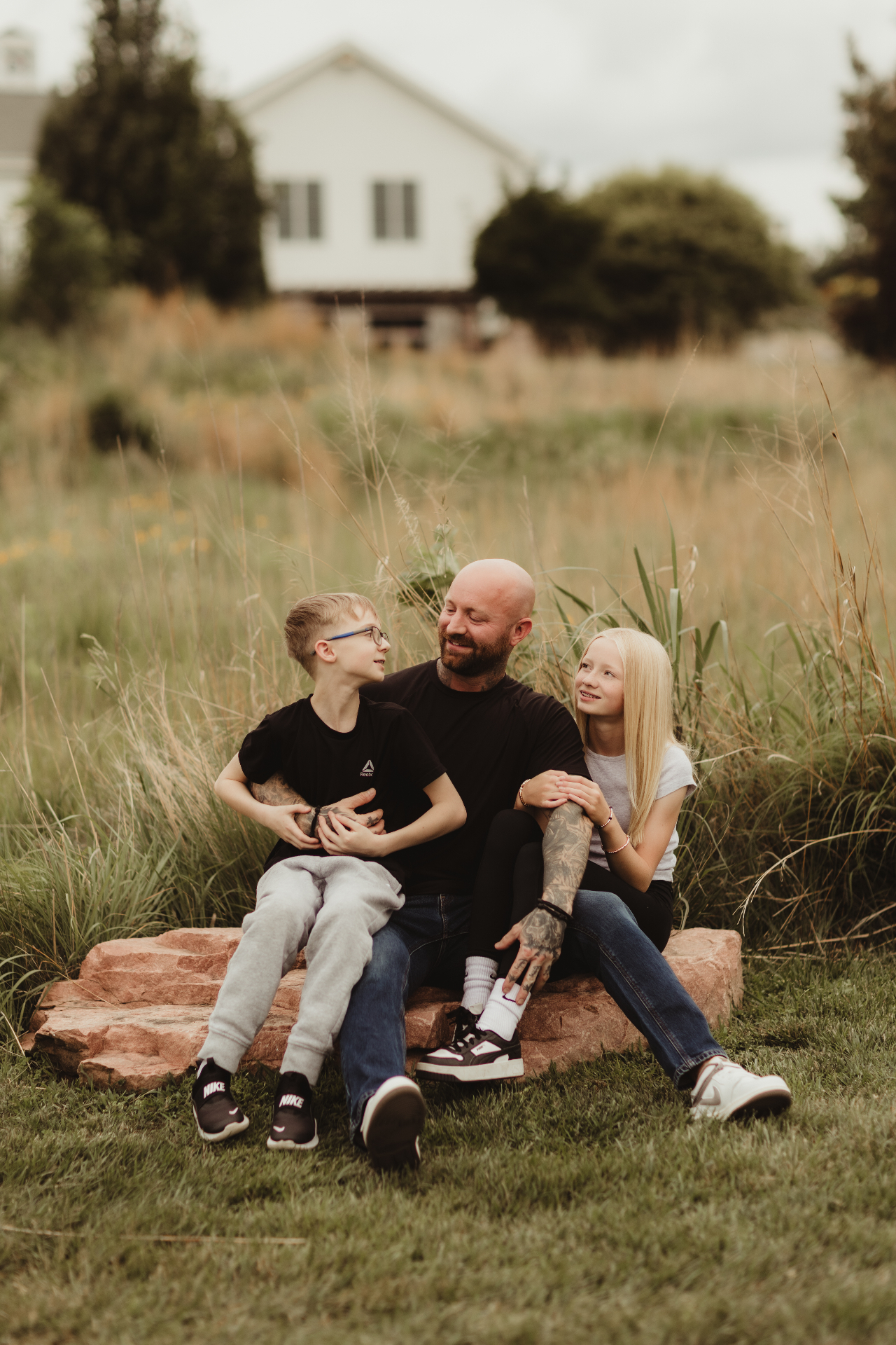 Michael with his kids in the tall grass