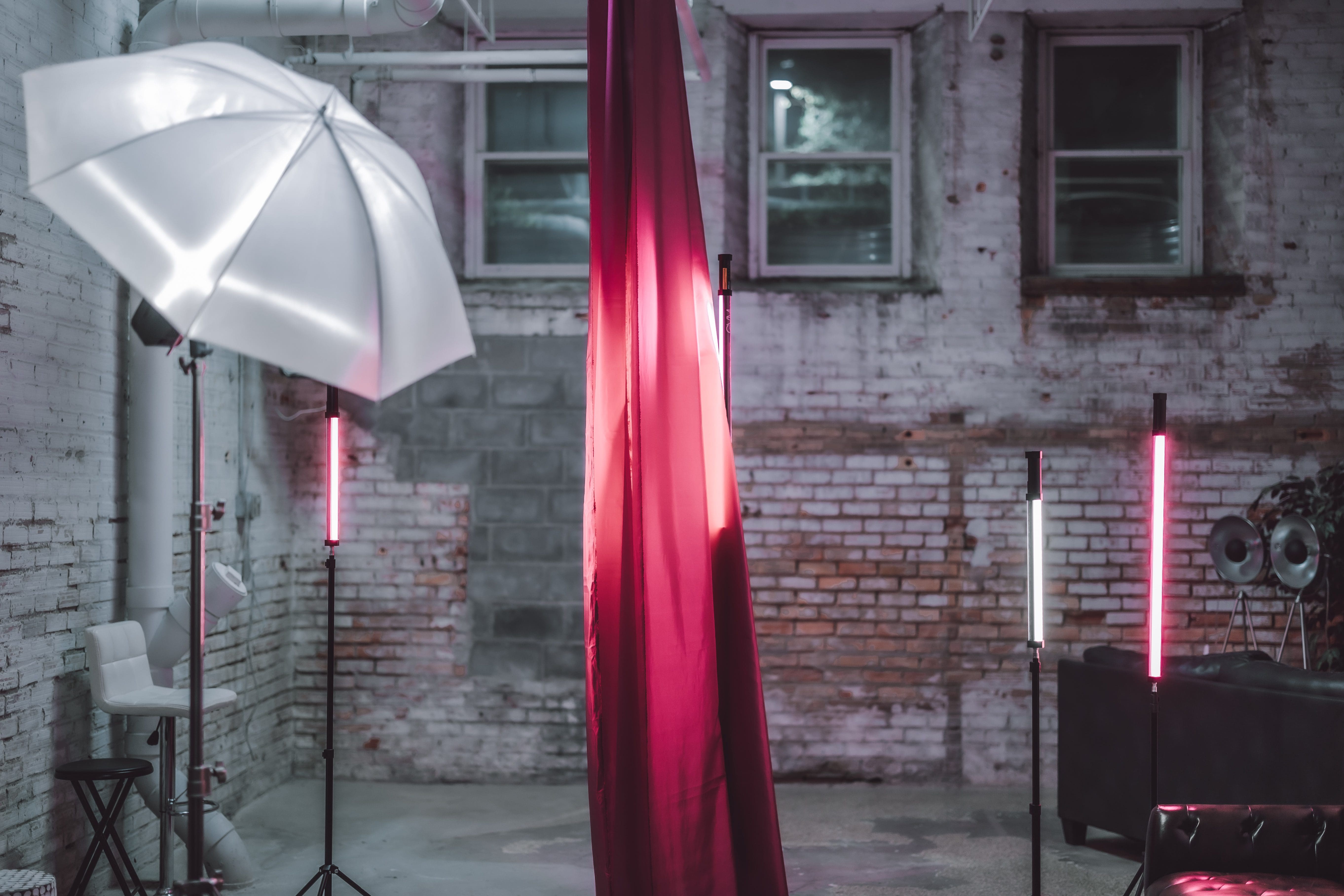 A red curtain and umbrellas in a room.